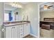 Bright and airy bathroom featuring a dual sink vanity, a large mirror, and an open doorway to the bedroom at 407 Glenmore Dr, Moncks Corner, SC 29461