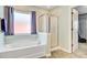 Bathroom featuring a bathtub with chrome fixtures, a glass shower, and access to a walk-in closet at 407 Glenmore Dr, Moncks Corner, SC 29461