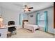 Cozy bedroom with a fan and desk space, enhanced by soft natural light and neutral walls for a comfortable setting at 407 Glenmore Dr, Moncks Corner, SC 29461