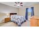 Cozy bedroom featuring a ceiling fan, window with curtains, and a comfortable bed with a decorative quilt at 407 Glenmore Dr, Moncks Corner, SC 29461