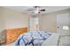 Comfortable bedroom featuring tan walls, carpet, door, chest of drawers and bed with patterned comforter at 407 Glenmore Dr, Moncks Corner, SC 29461
