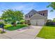 Beautifully landscaped two-story home with a manicured lawn, front porch, and an attached two-car garage at 407 Glenmore Dr, Moncks Corner, SC 29461