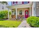 Cozy front porch with rocking chairs and blooming flower beds, creating an inviting entrance to the home at 407 Glenmore Dr, Moncks Corner, SC 29461