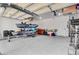 Spacious garage featuring high ceilings, storage racks and equipment on a level concrete floor at 407 Glenmore Dr, Moncks Corner, SC 29461