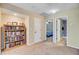 Hallway with open doorways featuring a built-in bookshelf for a library and convenient access to additional rooms at 407 Glenmore Dr, Moncks Corner, SC 29461