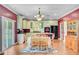 Eat-in kitchen with white cabinets, black appliances, island and hardwood floors at 407 Glenmore Dr, Moncks Corner, SC 29461