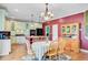 Eat-in kitchen with white cabinets, island, hardwood floors and modern appliances at 407 Glenmore Dr, Moncks Corner, SC 29461