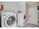 Functional laundry room featuring modern washer and dryer units plus convenient shelving to streamline chores at 407 Glenmore Dr, Moncks Corner, SC 29461