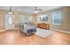 Comfortable living room featuring hardwood floors, a ceiling fan, and ample natural light at 407 Glenmore Dr, Moncks Corner, SC 29461