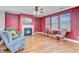 Inviting living room with hardwood floors, cozy fireplace, natural light and rocking chairs at 407 Glenmore Dr, Moncks Corner, SC 29461
