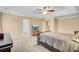 Open primary bedroom with tray ceilings, carpeting, television and seating to the side of a king bed at 407 Glenmore Dr, Moncks Corner, SC 29461