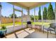 Relaxing screened porch with chairs overlooking a well-manicured backyard and private shed at 407 Glenmore Dr, Moncks Corner, SC 29461