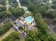 Aerial view showcasing the community pool, amenity center, surrounding trees and lush landscaping near a waterway at 4073 Blackmoor St, Mount Pleasant, SC 29466