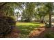 This backyard features a lush lawn, mature trees, and privacy landscaping at 4073 Blackmoor St, Mount Pleasant, SC 29466