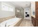 Bright bathroom featuring a standalone tub, glass enclosed shower, double vanity and neutral tile flooring at 4073 Blackmoor St, Mount Pleasant, SC 29466