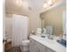 Bright bathroom featuring a shower with curtain, a large mirror, and vanity with drawers at 4073 Blackmoor St, Mount Pleasant, SC 29466