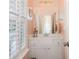 Charming bathroom featuring a white vanity, shuttered windows and decoratively painted walls at 4073 Blackmoor St, Mount Pleasant, SC 29466