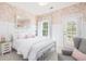 Inviting bedroom featuring a patterned wall covering, ample natural light and plush armchair at 4073 Blackmoor St, Mount Pleasant, SC 29466