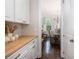 Butler pantry with wooden countertop, white cabinets, and a view into the dining room at 4073 Blackmoor St, Mount Pleasant, SC 29466