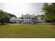 Grand clubhouse with manicured lawn and symmetrical design, providing a welcoming community focal point at 4073 Blackmoor St, Mount Pleasant, SC 29466