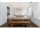 Formal dining room featuring striped wallpaper, hardwood floors, and elegant light fixture at 4073 Blackmoor St, Mount Pleasant, SC 29466