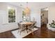 Dining room with dark floors, two large windows, natural light, and a rustic style table at 4073 Blackmoor St, Mount Pleasant, SC 29466