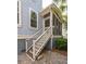 Exterior stairs leading to a screened in porch with wood railing, adjacent to a home with light blue siding at 4073 Blackmoor St, Mount Pleasant, SC 29466