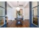Grand foyer with a decorative chandelier, hardwood floors, and a round table with vases at 4073 Blackmoor St, Mount Pleasant, SC 29466