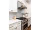 Kitchen featuring stainless steel range, herringbone tile, and white cabinets at 4073 Blackmoor St, Mount Pleasant, SC 29466