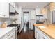 White kitchen with herringbone backsplash, stainless appliances, and butcher block island at 4073 Blackmoor St, Mount Pleasant, SC 29466