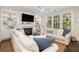Comfortable living room with large windows, fireplace, built-in shelving, and a view of the outdoor greenery at 4073 Blackmoor St, Mount Pleasant, SC 29466