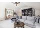 Bright living room with a large bookshelf, comfortable seating, and natural light at 4073 Blackmoor St, Mount Pleasant, SC 29466