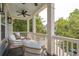 Inviting porch with cushioned seating, ceiling fan and wooded surroundings at 4073 Blackmoor St, Mount Pleasant, SC 29466
