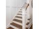 Stylish staircase with white wainscoting and dark wood steps, adding a touch of elegance to the home's interior at 4073 Blackmoor St, Mount Pleasant, SC 29466