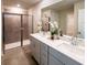 Modern bathroom with double vanity sinks and a glass-enclosed shower at 421 Radiant Blue Way, Summerville, SC 29486