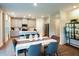 Stylish open-concept kitchen with an island, modern appliances and adjoining dining space at 421 Radiant Blue Way, Summerville, SC 29486