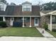 Charming brick townhouse with a well-maintained lawn and welcoming front porch at 5021 Popperdam Creek Dr, North Charleston, SC 29418