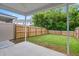 View of the home's backyard featuring a privacy fence, green grass, and a covered patio at 5133 Park Creek Ave, North Charleston, SC 29418