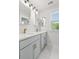 Bathroom with double vanity, gray cabinets, marble floors, and natural lighting from a window at 5133 Park Creek Ave, North Charleston, SC 29418