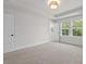 Sunlit bedroom features neutral walls, carpet, with multiple large windows allowing ample natural light at 5133 Park Creek Ave, North Charleston, SC 29418