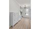Well-lit entryway with modern storage cabinets, wooden floors, and decorative light fixture at 5133 Park Creek Ave, North Charleston, SC 29418