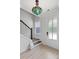Bright entryway with a decorative light fixture, wooden floors, and a staircase at 5133 Park Creek Ave, North Charleston, SC 29418