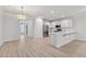 Spacious kitchen area with stainless steel appliances, quartz countertop bar, and modern lighting at 5133 Park Creek Ave, North Charleston, SC 29418