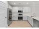 Sleek kitchen with stainless steel appliances, white cabinets, and quartz countertops at 5133 Park Creek Ave, North Charleston, SC 29418