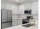 Bright kitchen featuring white cabinets, subway tile, stainless appliances, and quartz countertops at 5133 Park Creek Ave, North Charleston, SC 29418