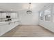 Open-concept kitchen and eat-in area feature a quartz countertop bar with modern pendant lighting at 5133 Park Creek Ave, North Charleston, SC 29418