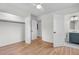 Bedroom with hardwood floors, closet, open doorway, and adjacent bathroom at 5172 Sterrett St, North Charleston, SC 29405