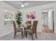 Cozy dining area with a glass table, stylish wicker chairs, and ample natural light from the window at 5172 Sterrett St, North Charleston, SC 29405