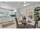 Cozy dining area with a glass table, stylish wicker chairs, and ample natural light from the window at 5172 Sterrett St, North Charleston, SC 29405
