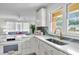 Bright kitchen featuring white cabinets, stainless steel sink, and modern appliances and finishes at 5172 Sterrett St, North Charleston, SC 29405